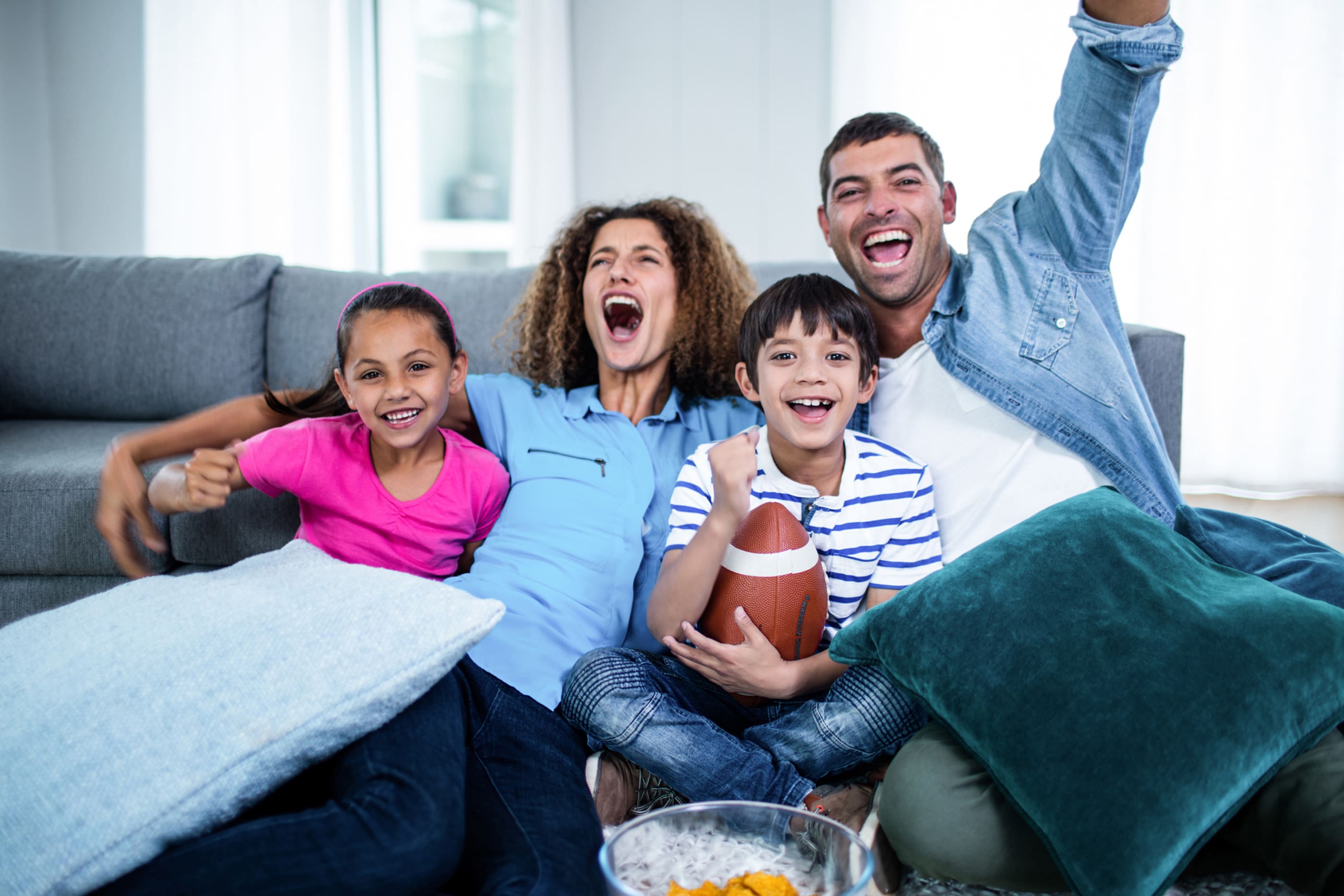 family watching sports on tv and cheering