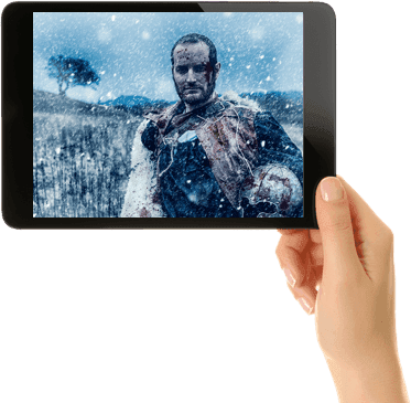 hand holding tablet with movie streaming