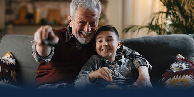 Grandfather and grandson watching TV