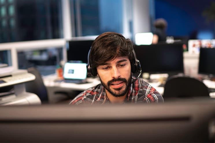 Man with headset working on computer