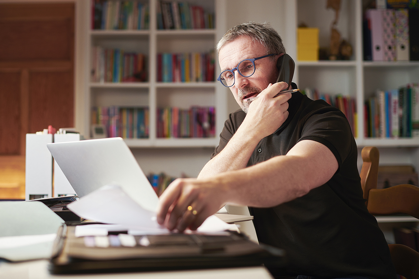 Man talking on phone in home office