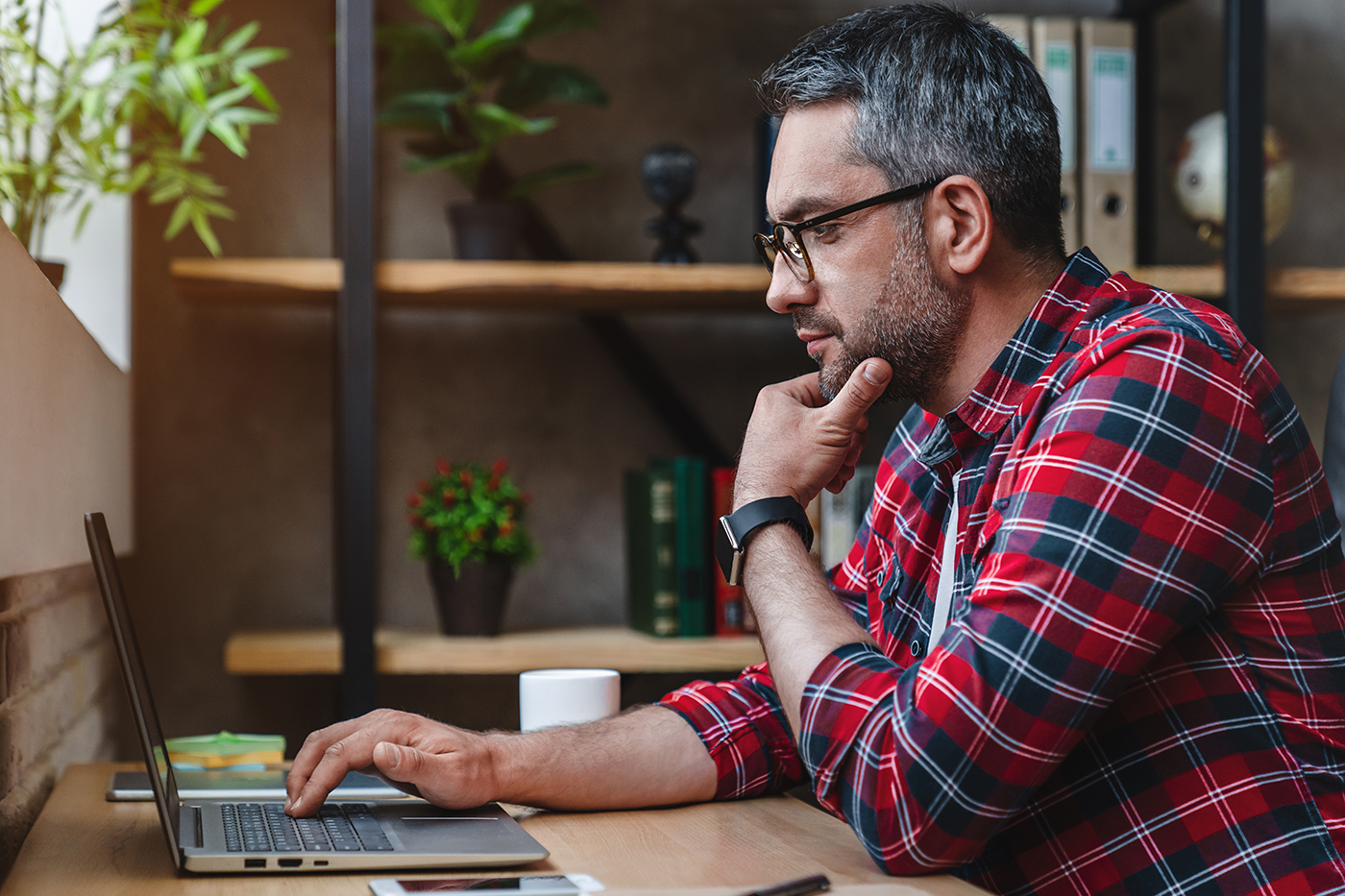 man at desk working on laptop