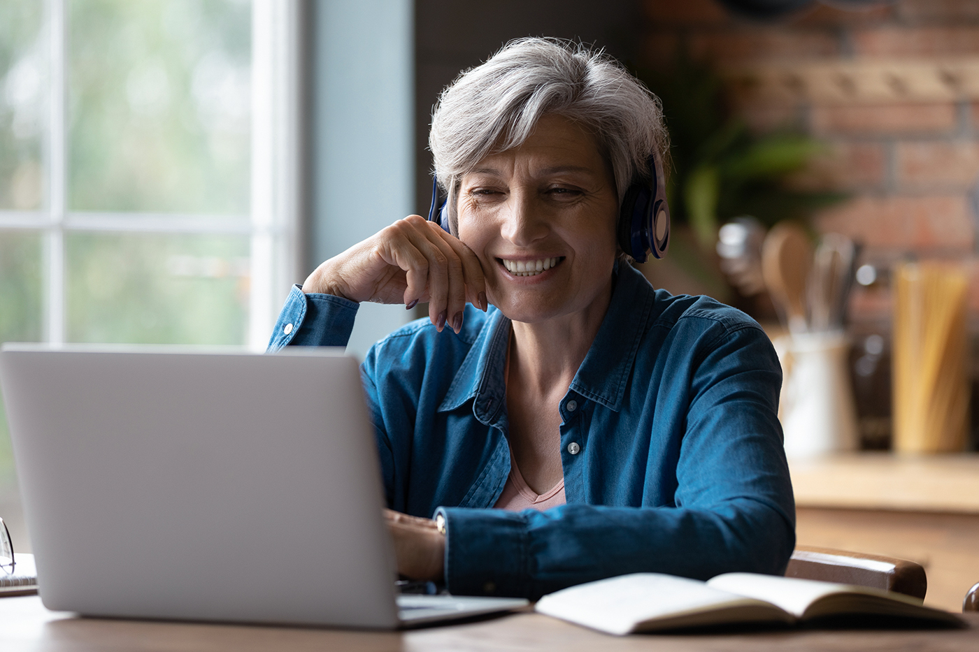 woman using laptop at kitchen table