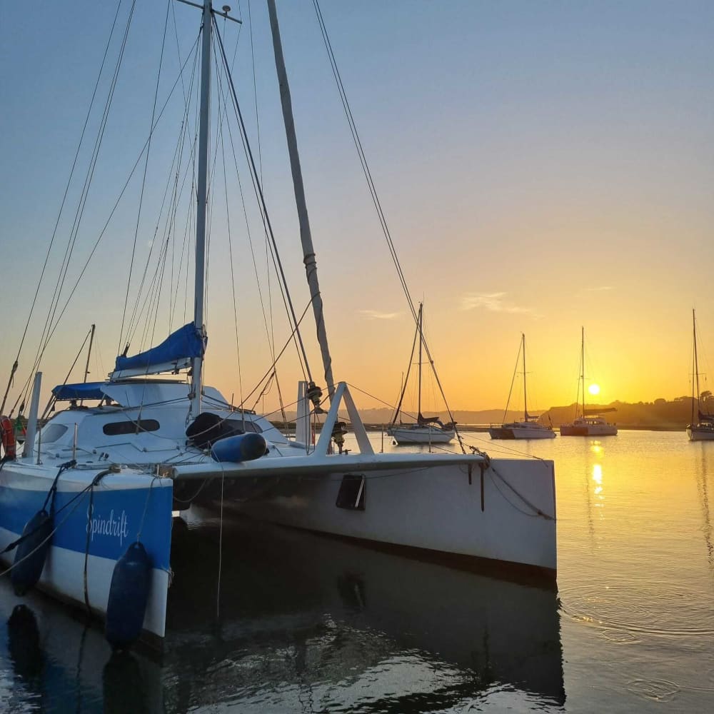 Discover Algarve coast as the sun sets on a catamaran