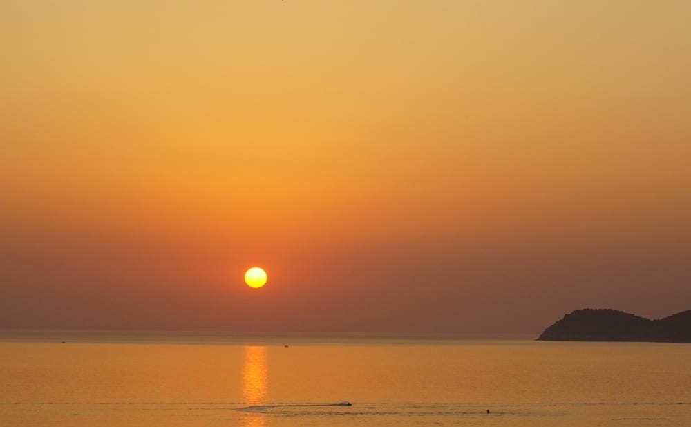 Volcanic Sunset: Aperitif on a Boat between Caves and Legends