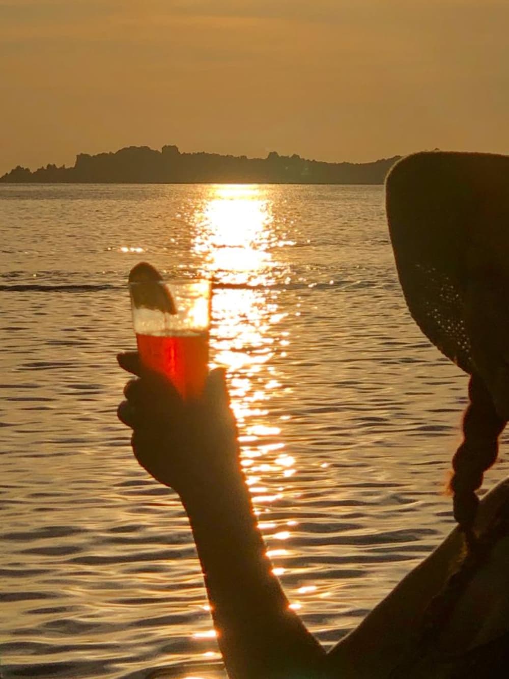 Exclusive sunset aboard a luxurious 14-meter catamaran in the heart of the Maddalena Archipelago with sunset over the Strait of Bonifacio