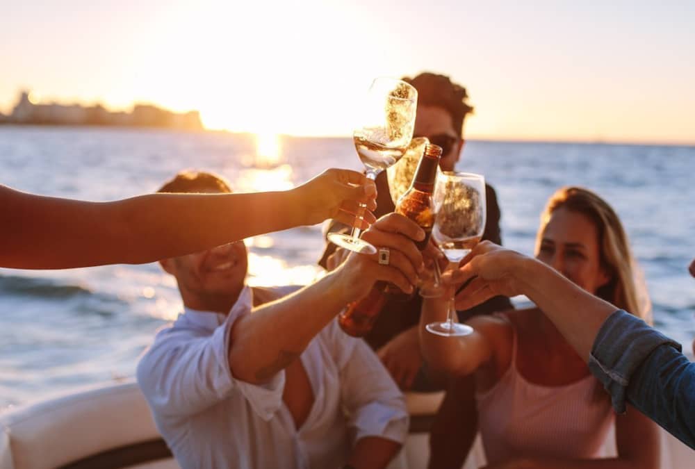 Aperitif on a boat at sunset in front of Gallinara Island