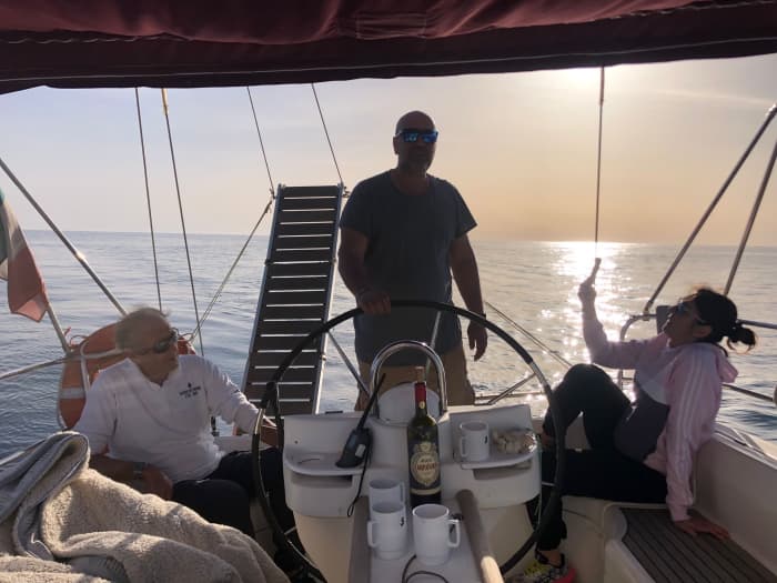Sunset aperitif on a sailboat off the coast of Ostia