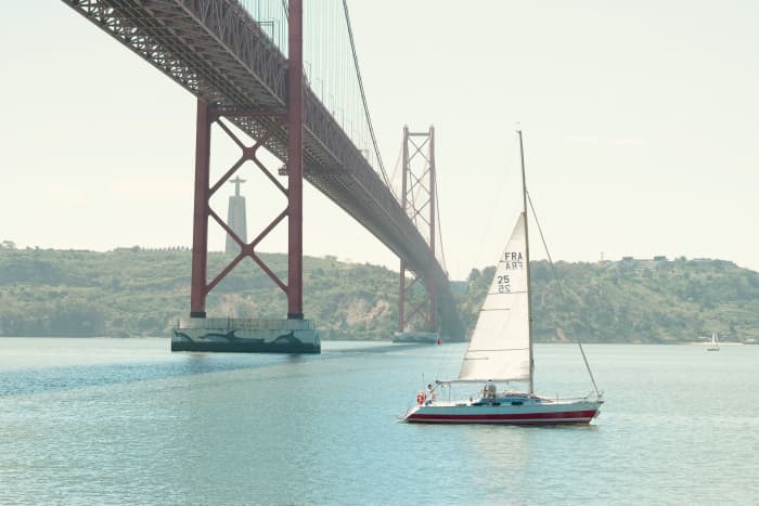 Explore Lisbon aboard a sailboat on the Tagus River, in a private sunset experience.
