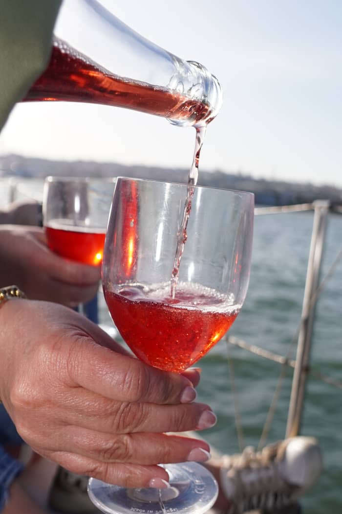 Explore Lisbon aboard a sailboat on the Tagus River, in a private sunset experience.