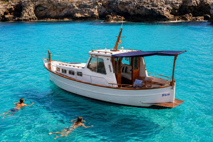 Sunset boat trip in a Menorcan llaüt with a skipper from Mahón