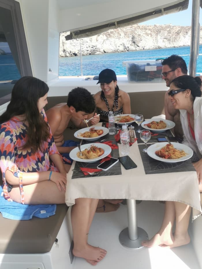 Explore Mykonos and enjoy a full day of sailing on a catamaran