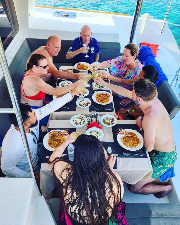 Explore Mykonos and enjoy a full day of sailing on a catamaran