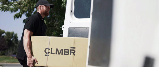 person loading clmbr machine into van