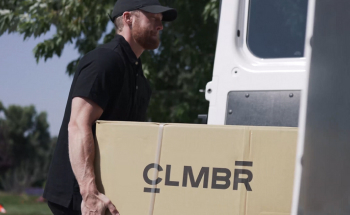 Person loading CLMBR into van