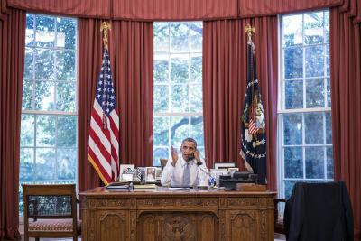 President Barack Obama talks on the phone with Cuba President Raúl Castro in the Oval Office.