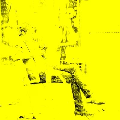 saturated image of a man sitting on bench