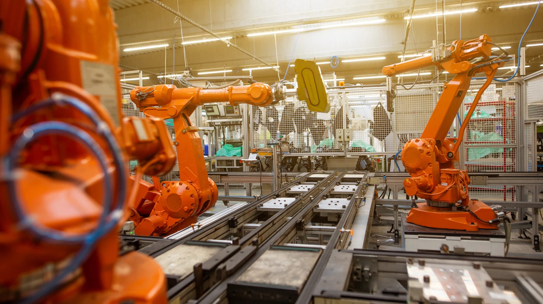 Industrial robots working along an automated factory conveyor