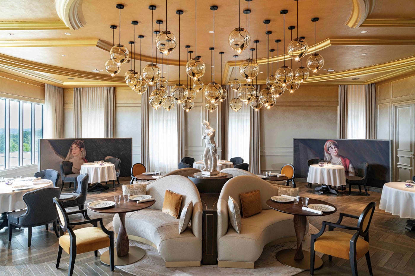 Dining room of Le Royal, the Michelin-starred restaurant at the Royal Champagne Hotel & Spa, with a gilded ceiling and glass chandeliers