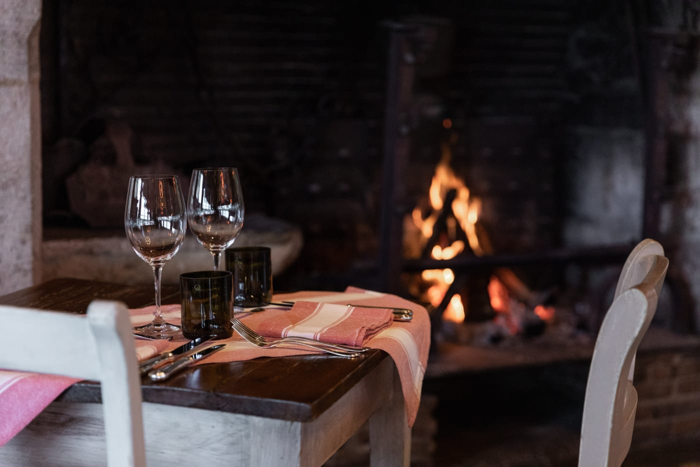 Table laid by the open fire at La Table du Lavoir, the country inn of Les Sources de Caudalie