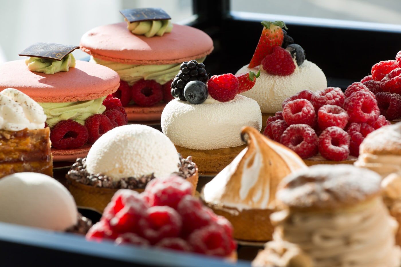 Afternoon tea pastries at the Grand Hôtel in Saint-Jean-de-Luz: macarons, raspberry tartlets and meringue tarts