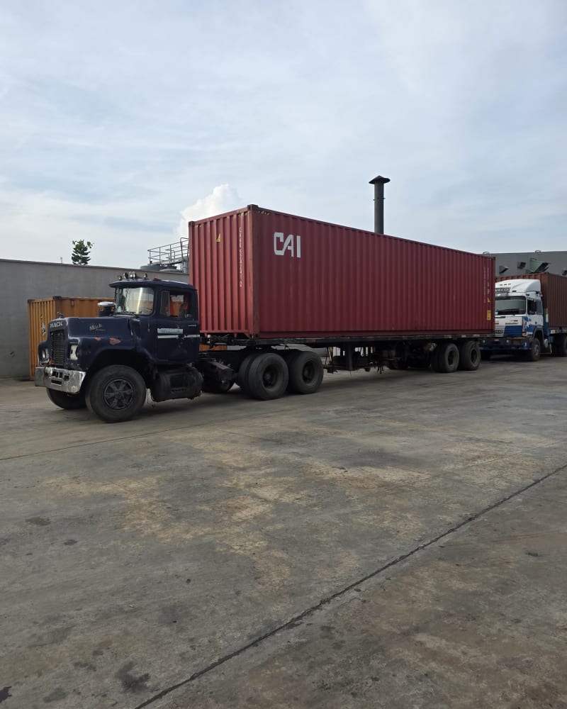 A shipping container on a haulage truck, ready for delivery