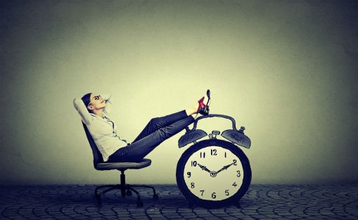 photo of a woman leaning back at her desk enjoying free time