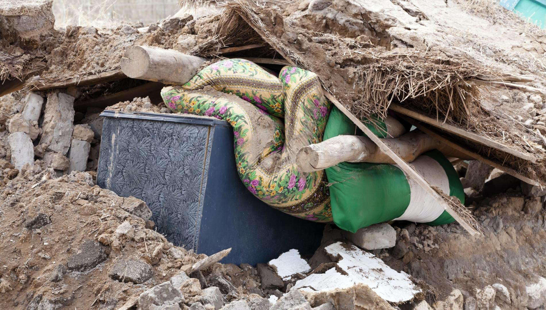 Household furnishings buried under building rubble following an earthquake