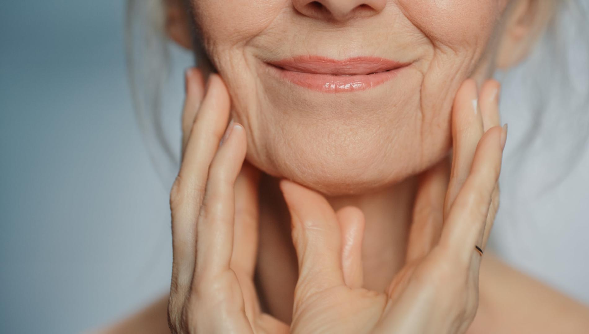  Older woman touching her neck, enjoying soft skin, representing dignity and grace in old age