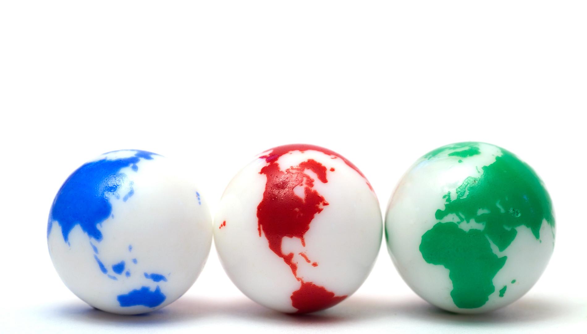 Group of three marbles showing all major land-masses