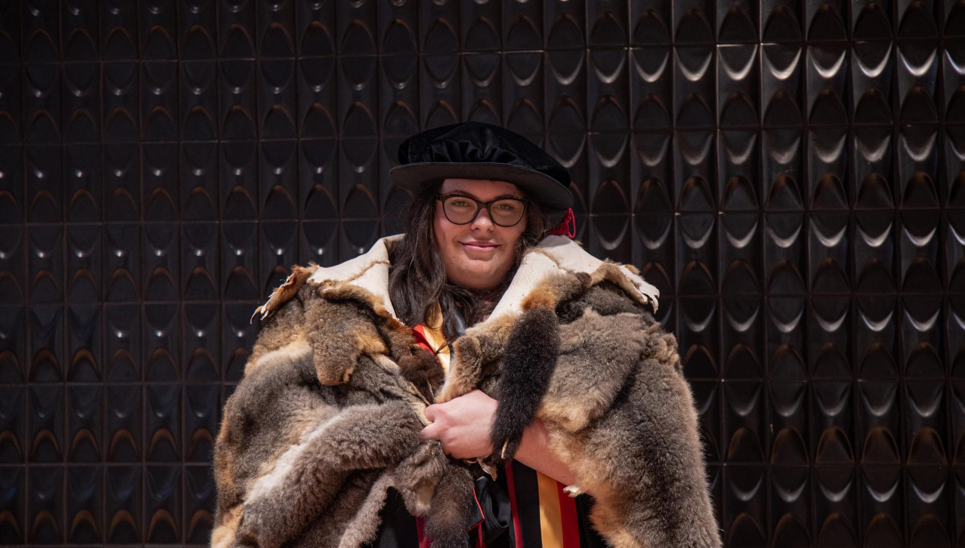 Portrait photo of Monash graduate Dr Victoria Gentile in a possum fur cloak