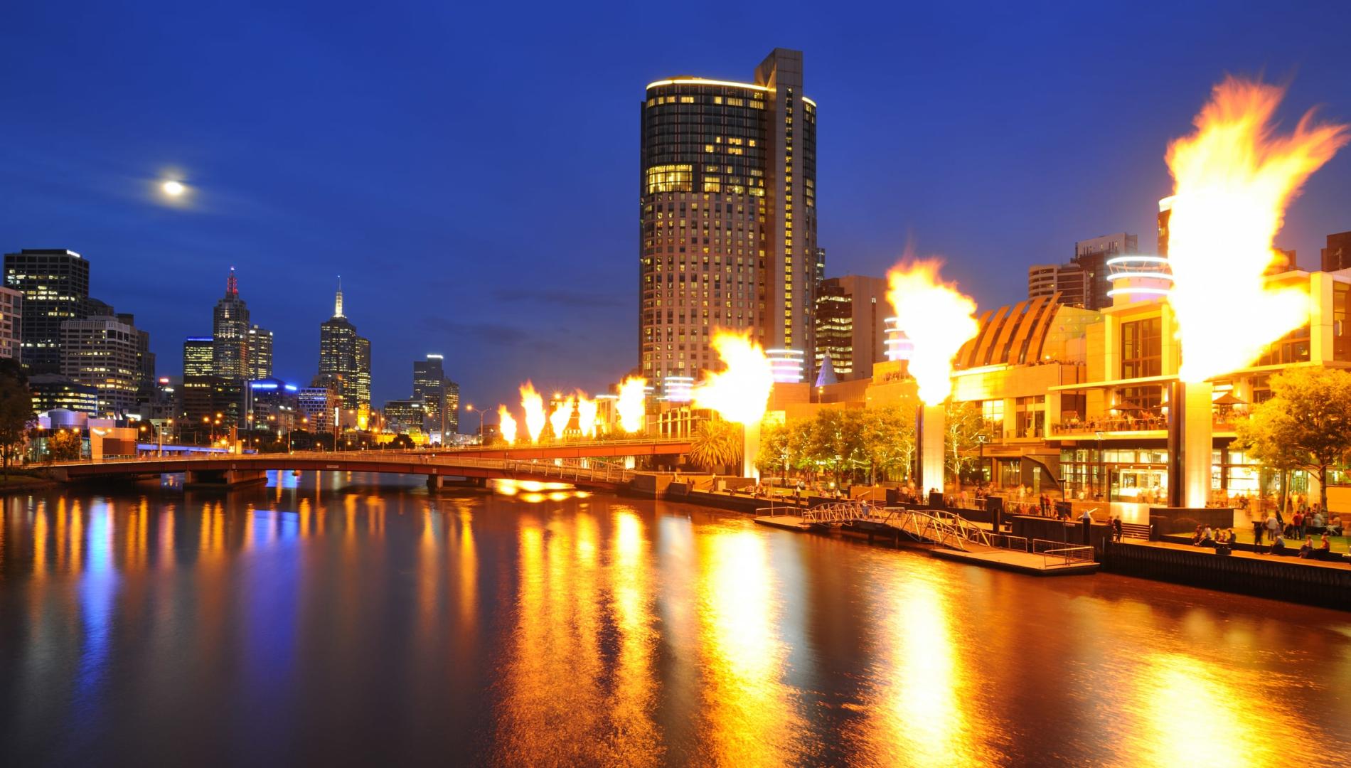 The Crown casino and entertainment complex on the Yarra River in Melbourne, with fireballs shooting into the air 