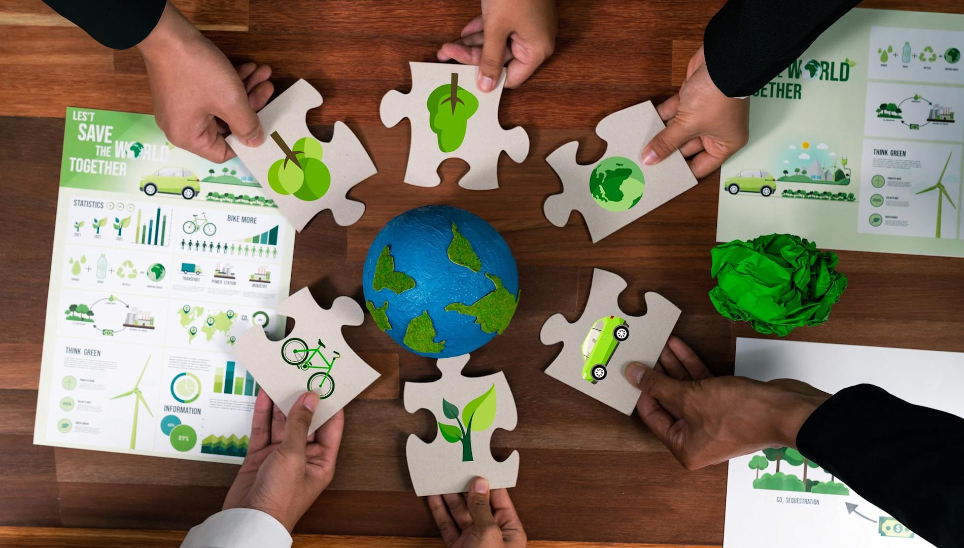 Group of business people holding eco icon jigsaw puzzle.