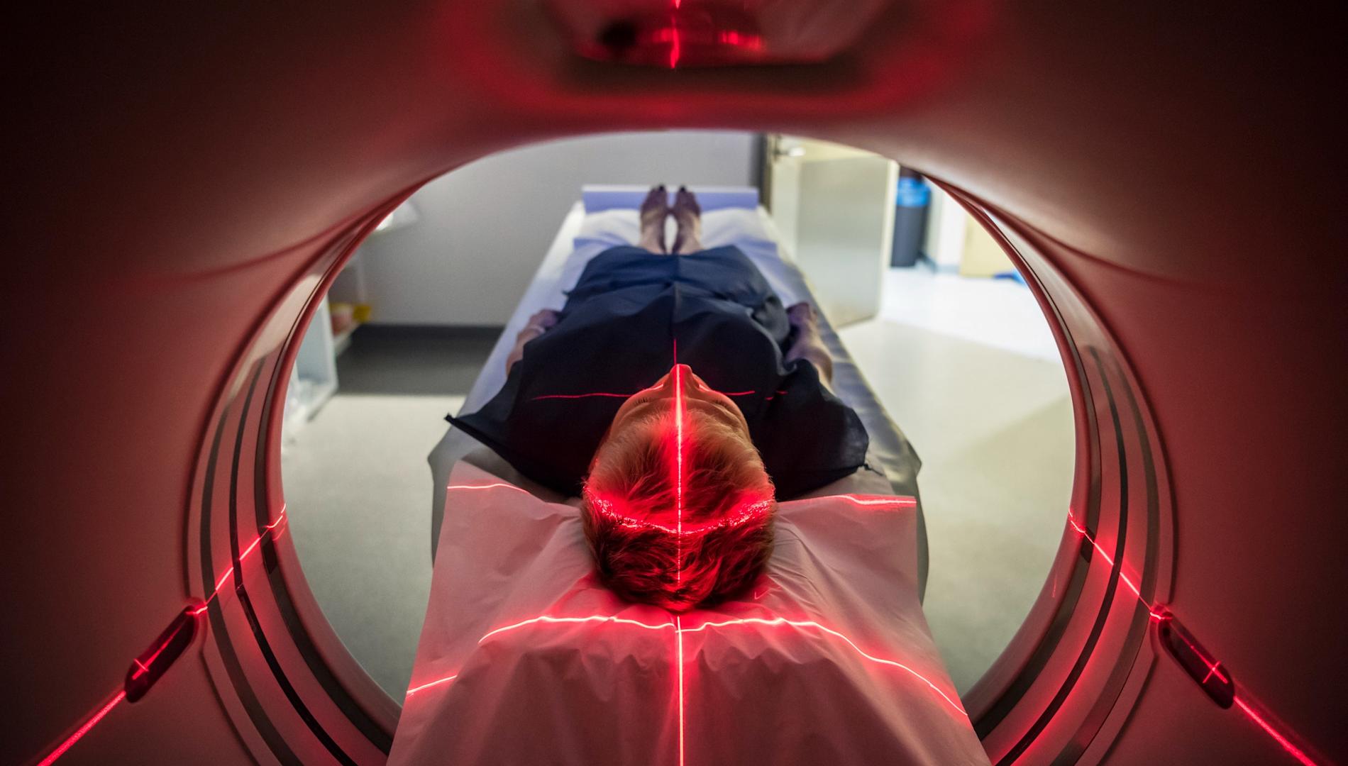 Patient lying inside a medical scanner in hospital