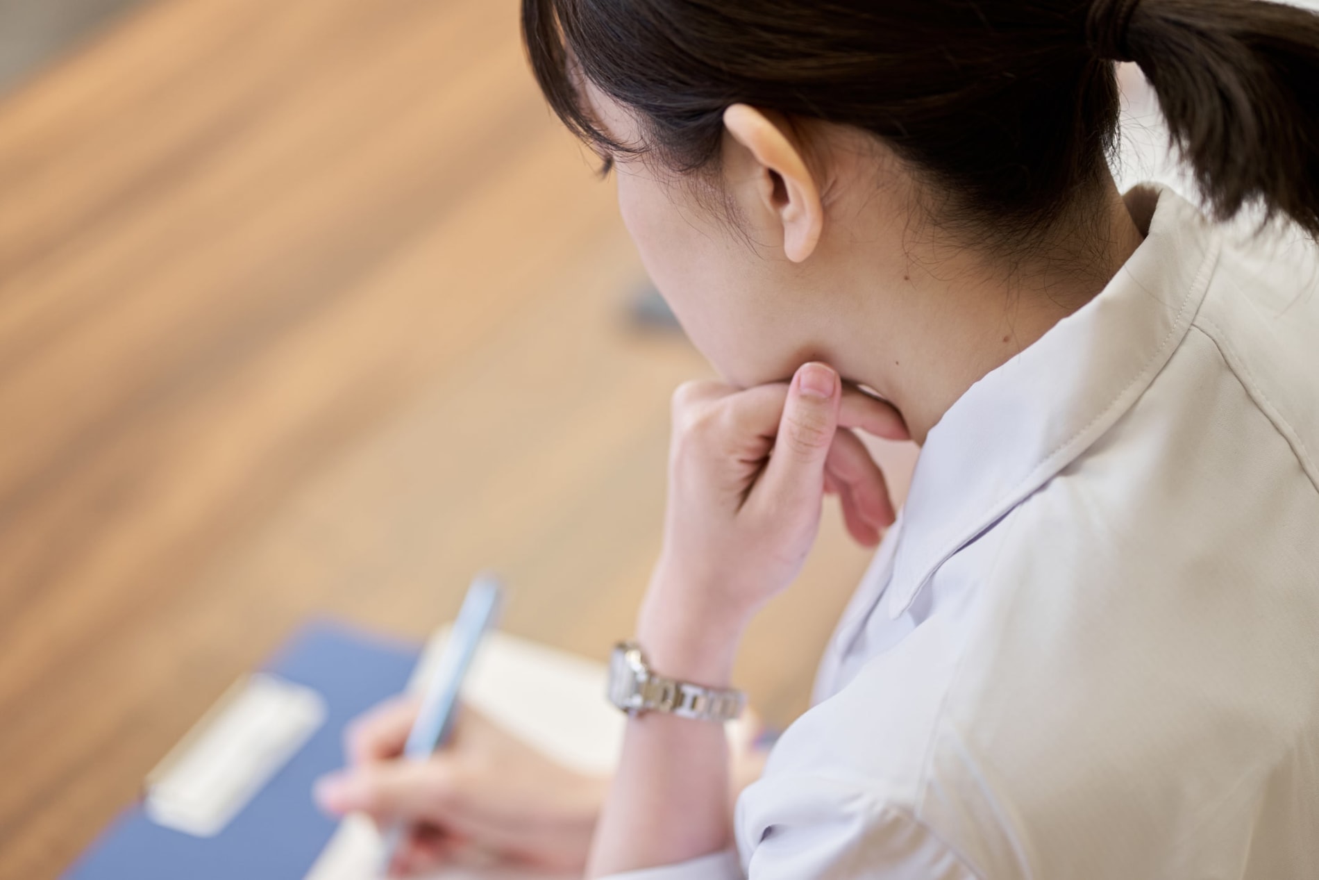 A female medical student taking notes in a lecture 