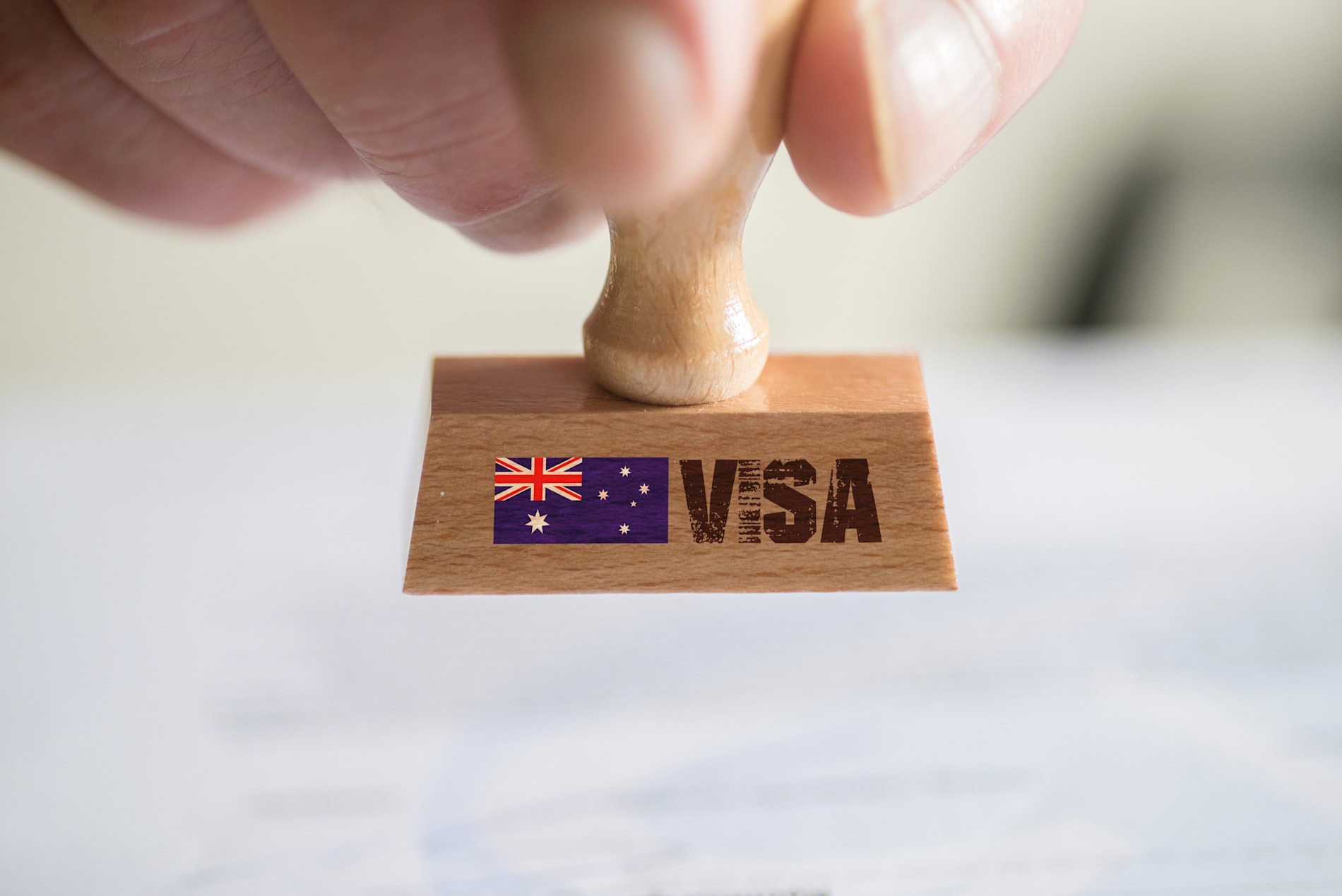 A wooden stamp emblazoned with the Australian flag and the word 'VISA'