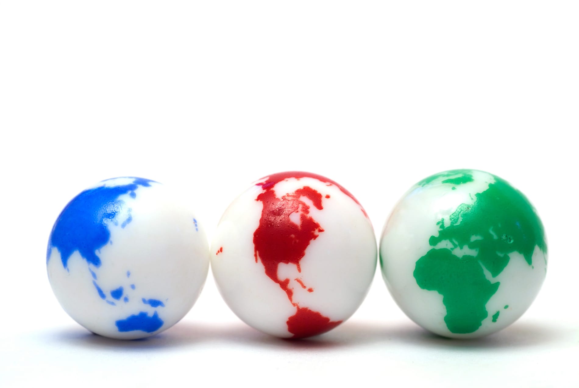 Group of three marbles showing all major land-masses