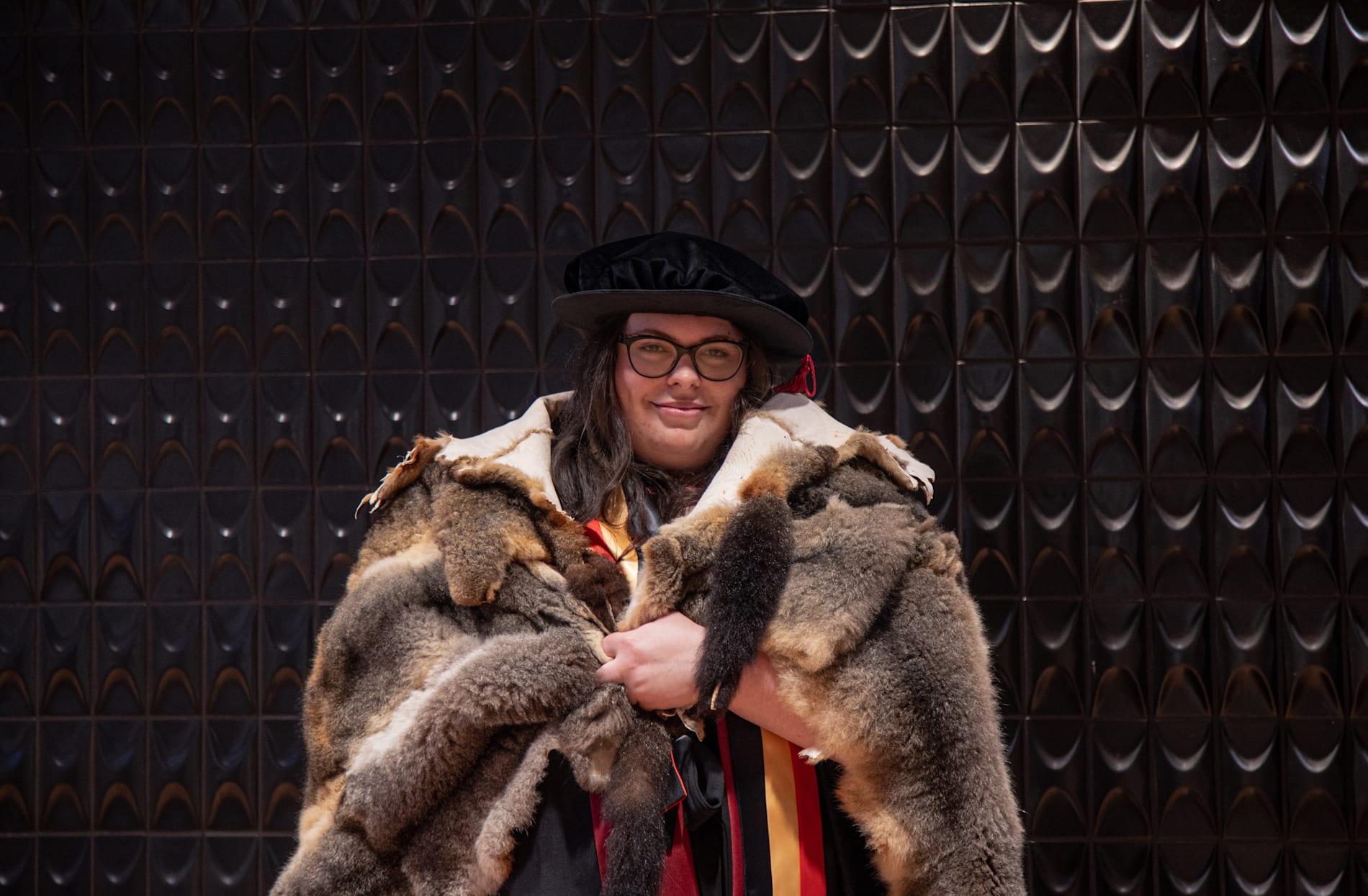 Portrait photo of Monash graduate Dr Victoria Gentile in a possum fur cloak