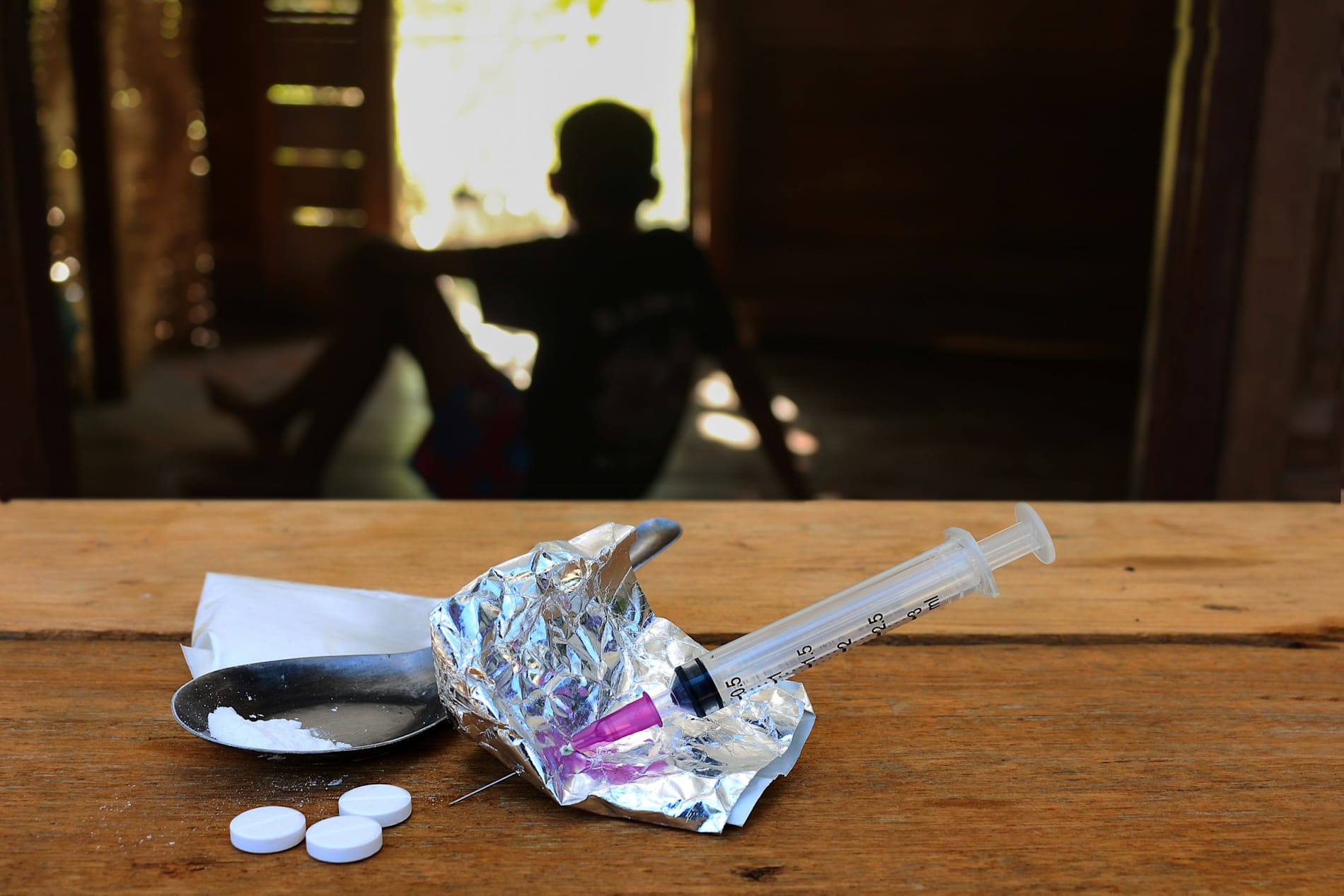 drug use concept, syringe, silver paper on a table.