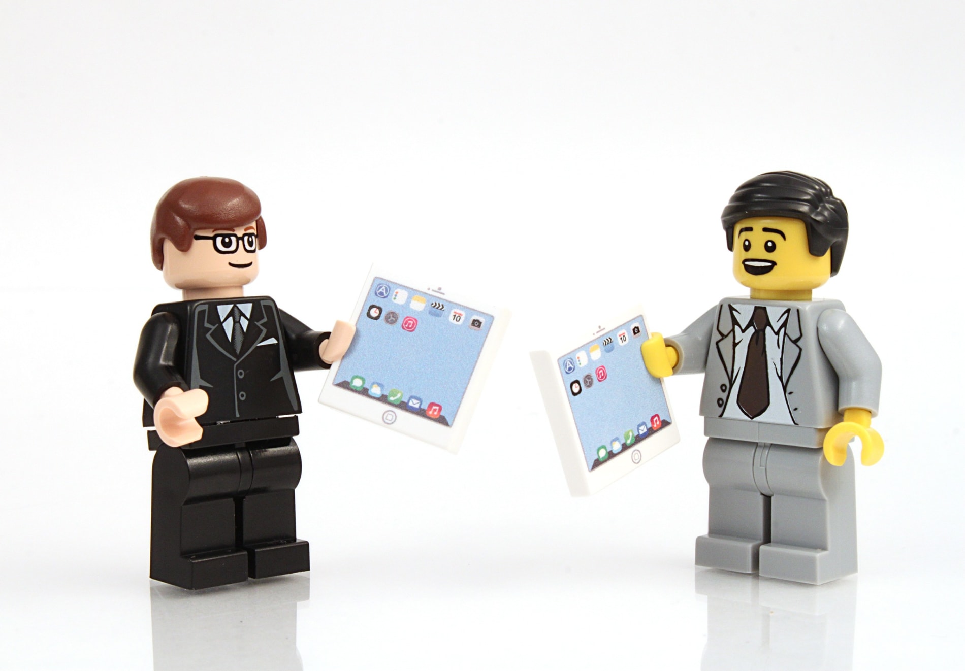Studio shot of Lego minifigure businessman with tablets.