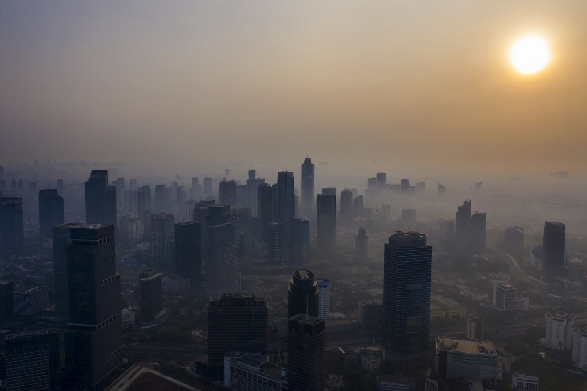 Aerial view at dusk of Jakarta skyscrapers amid air pollution 