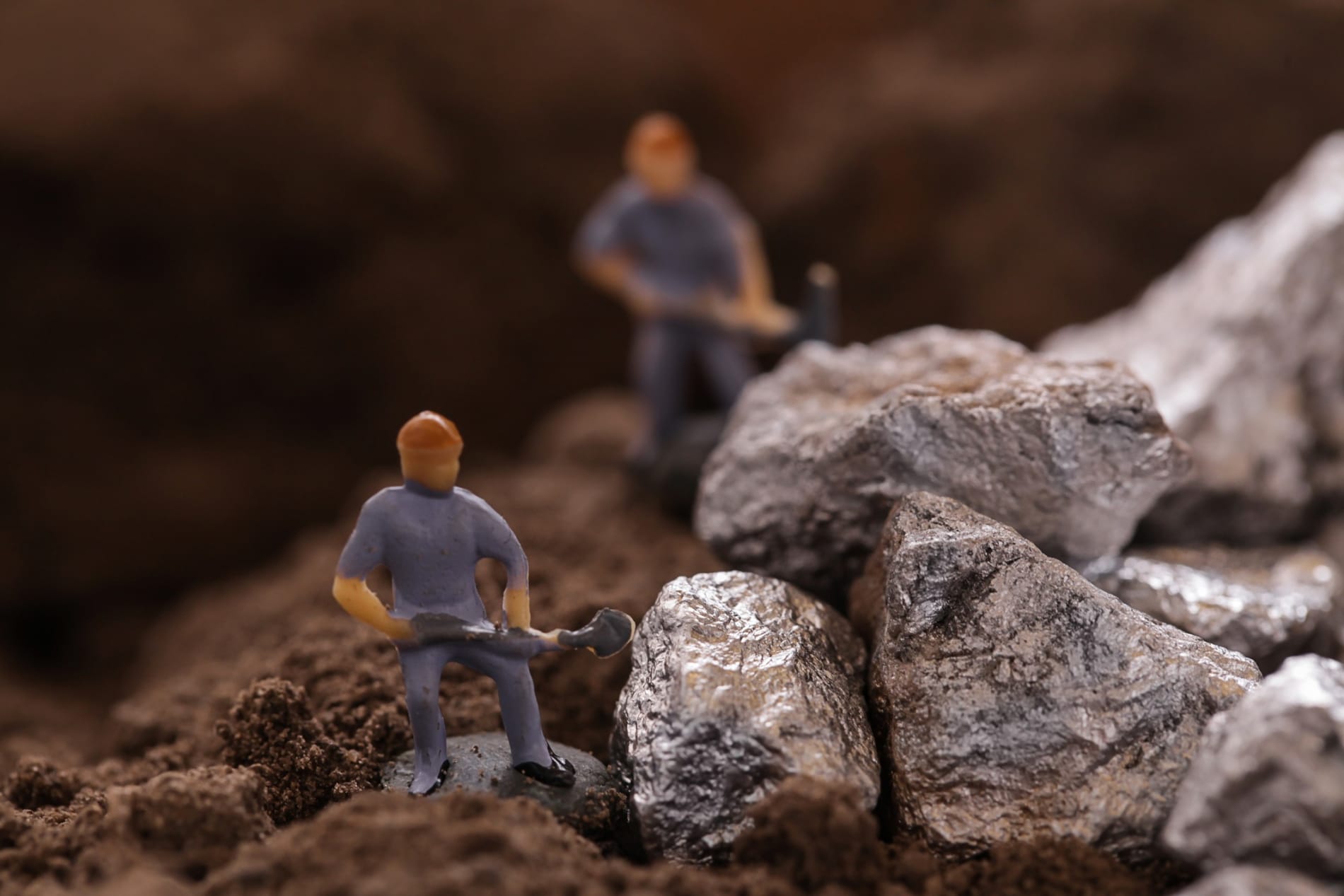 Mining of Cobalt. Miniature worker mining metal 