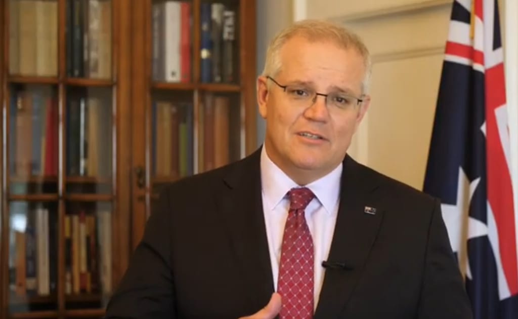 Scott Morrison speaking if front of Australian flag