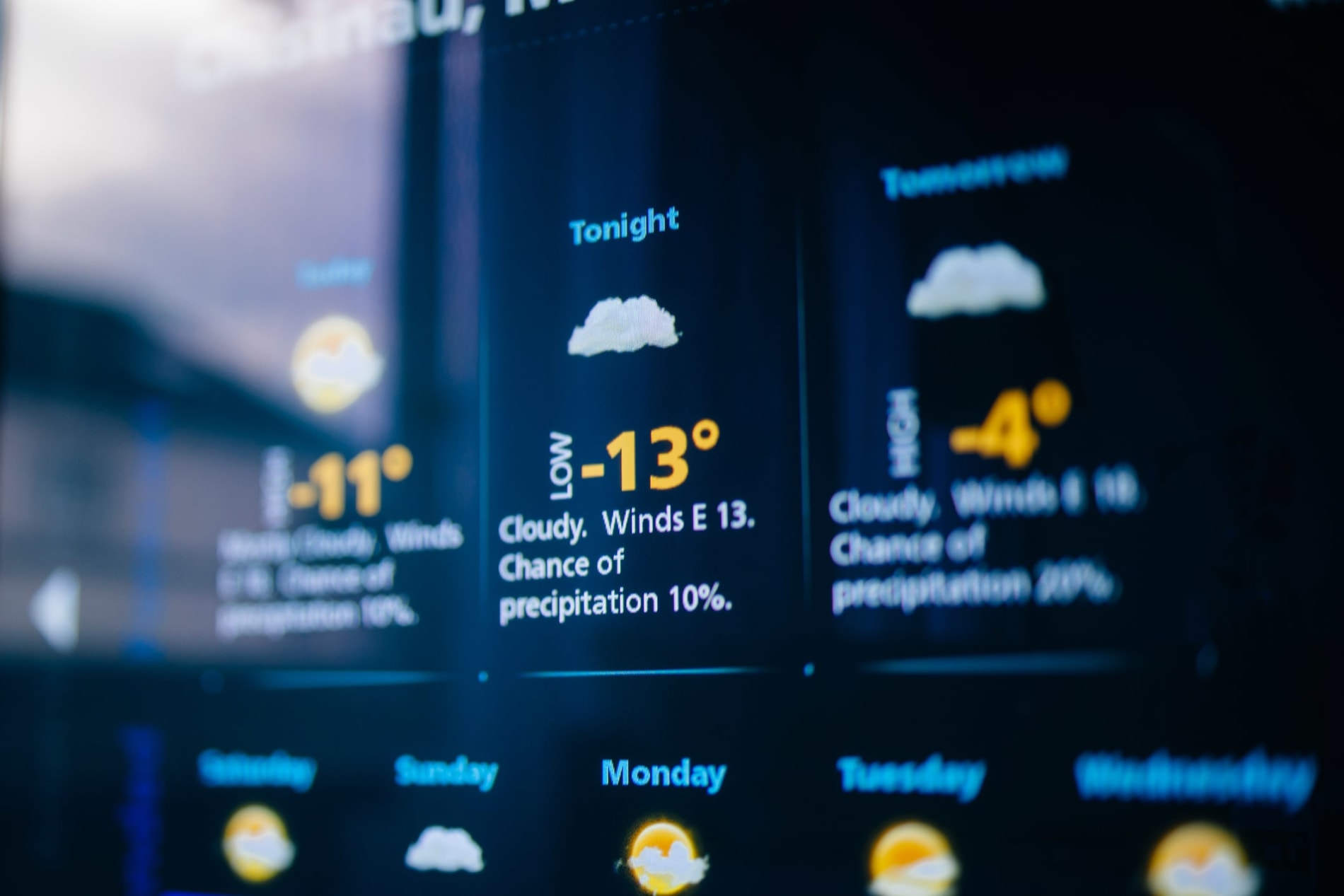 Weather forecast interface on a modern digital display showing cold weather for the next days