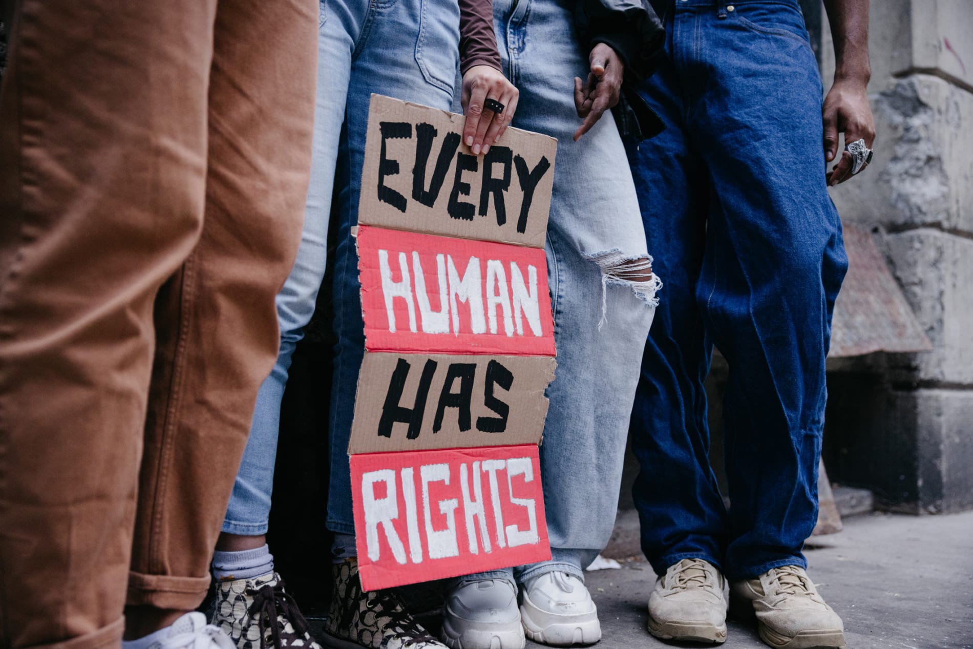 Protestors holding a sign that reads: 'Every human has rights'