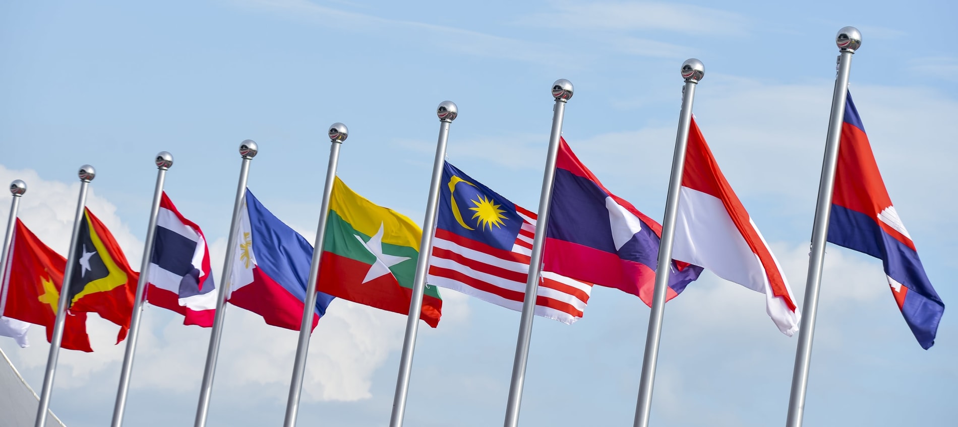 National flags of Southeast Asia flying with a blue-sky background