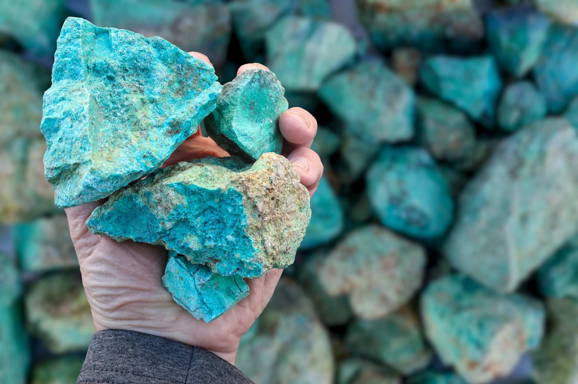 Blue green copper (Cu) oxide ore, held in hand