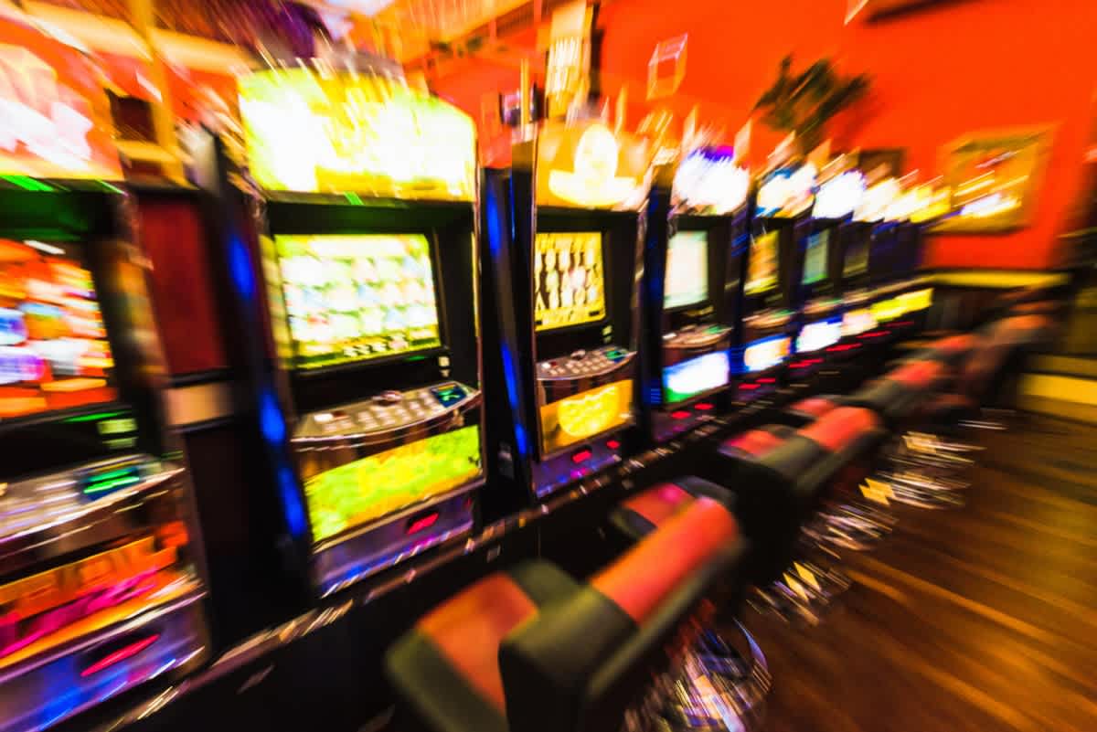 Line of poker machines inside a gambling venue.