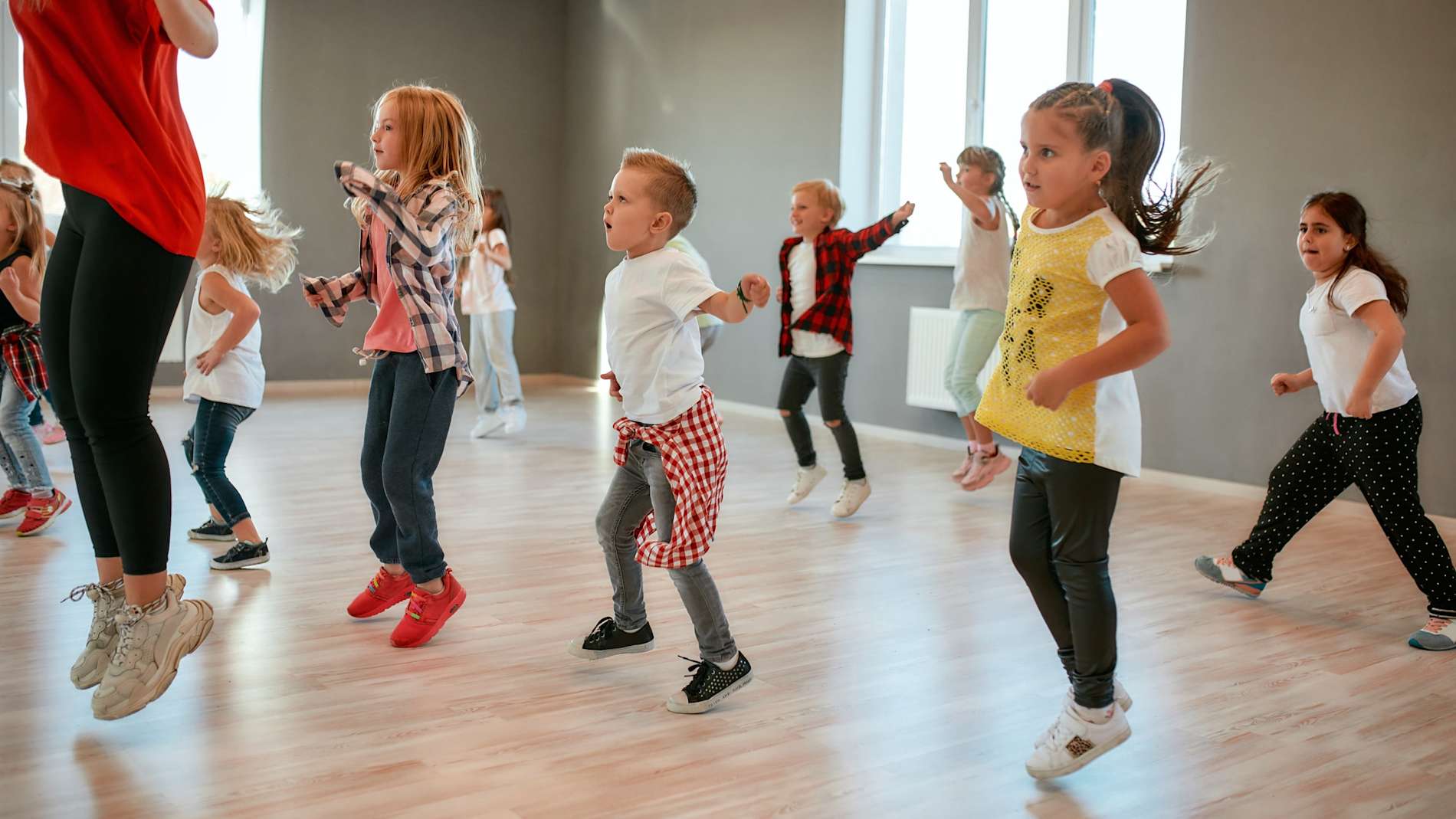 Group of little boys and girls dancing while having choreography class in the dance studio.