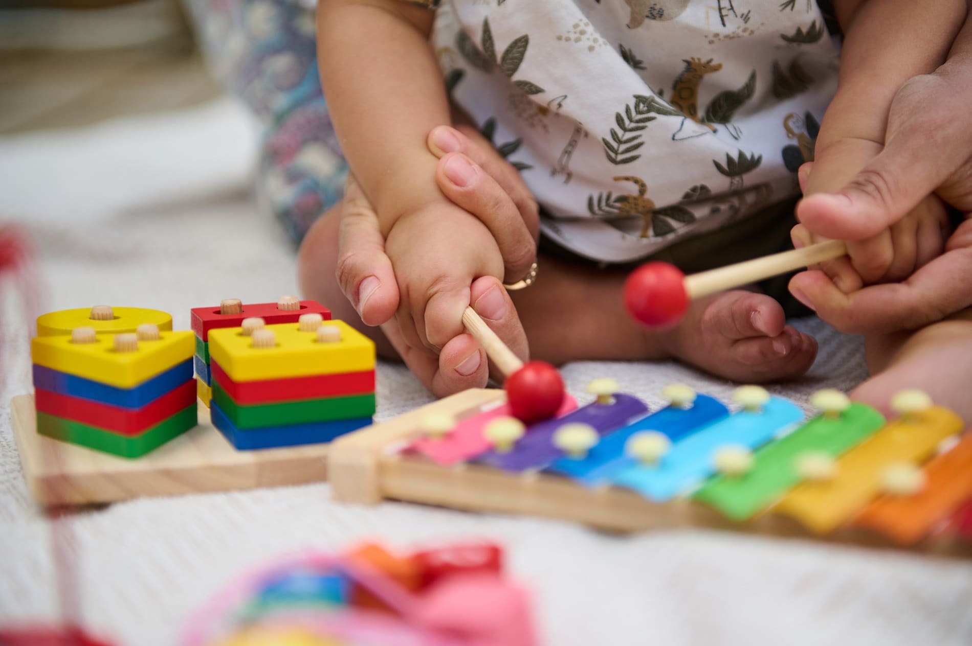Young child playing with colourful educational toys